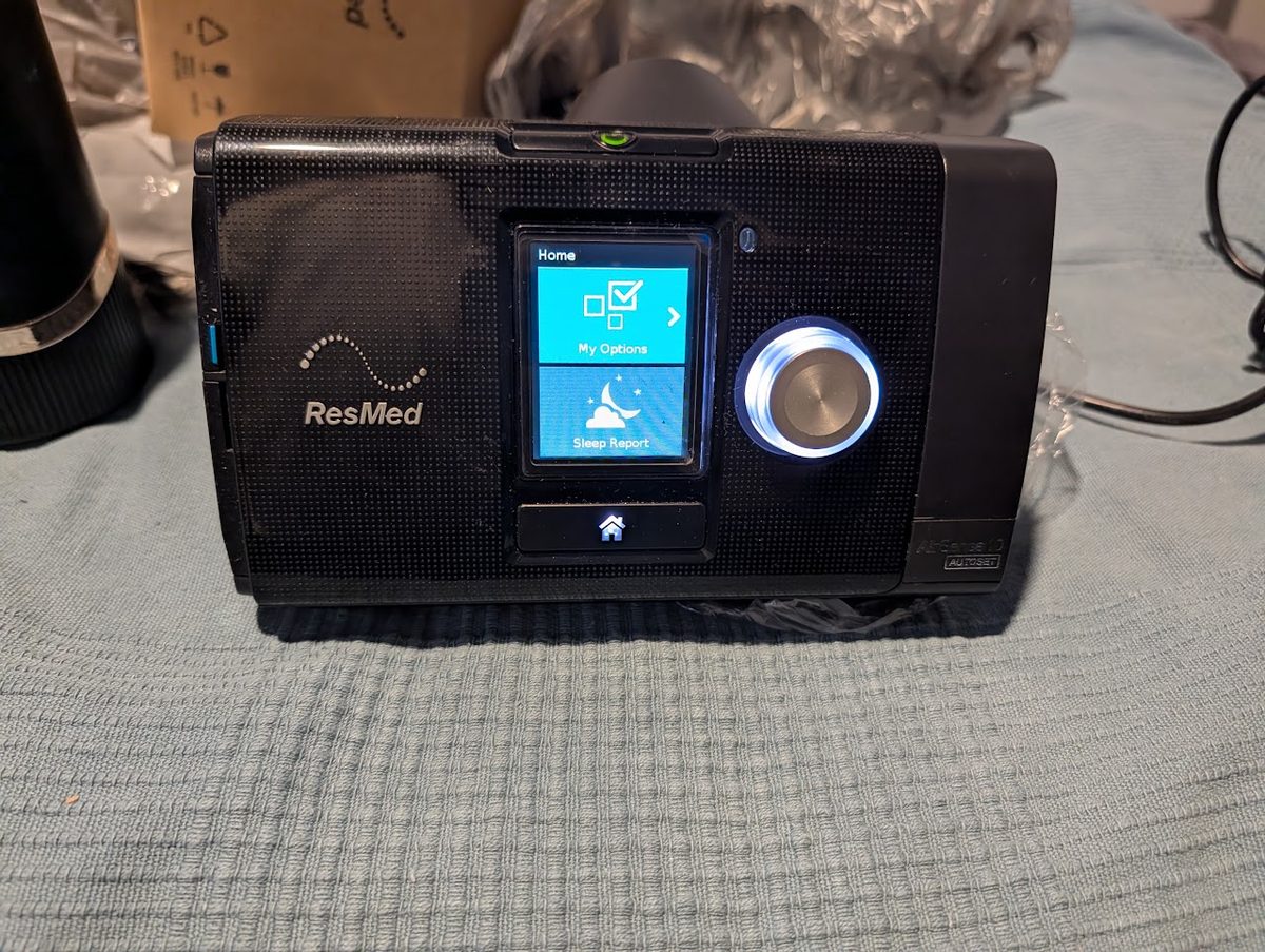 ResMed AirSense 10 AutoSet CPAP front view, screen on